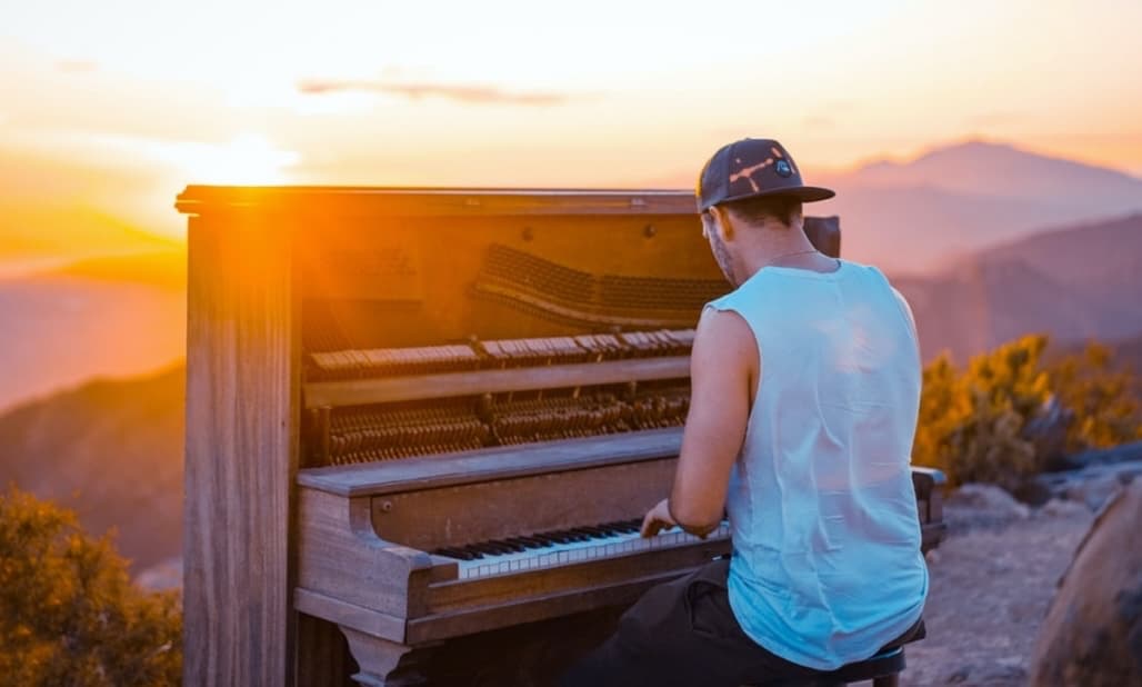 NY Piano School blog post image of a man in a hat playing the piano.