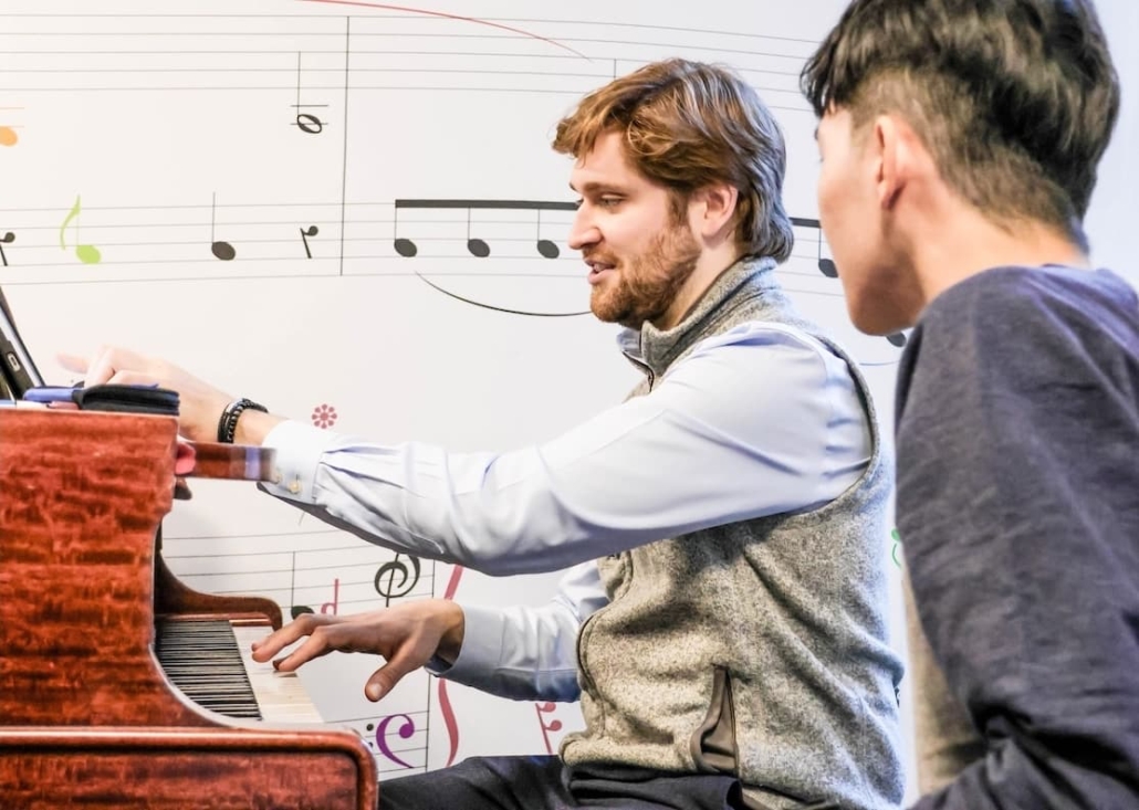 Adult student sitting at the piano.