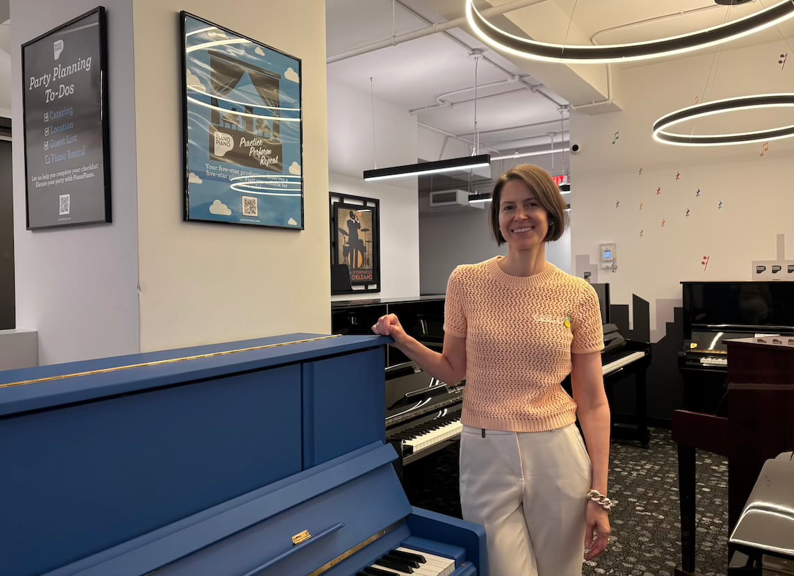 President of PianoPiano standing in front of a blue KPOP piano.